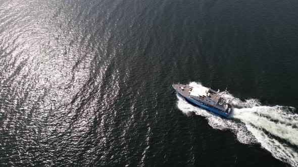 Ariel view of coast guard powerboat cruising in high speed. Speedboat border guard patrol the sea.