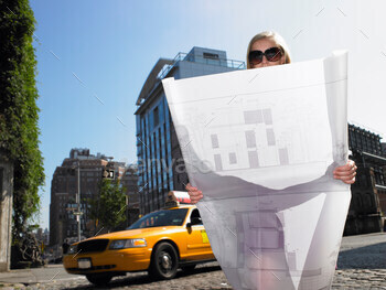 Architect with blue prints in the street