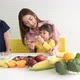Asian mother, feeding apple fruits for her two daughters - VideoHive Item for Sale