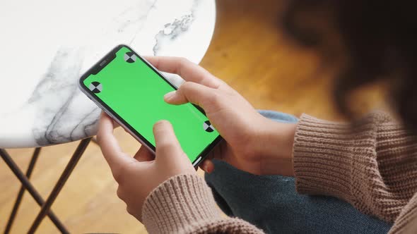 Woman Holding Mobile Phone with Green Screen Chroma Key and Marks Standing in Shopping Center Ready