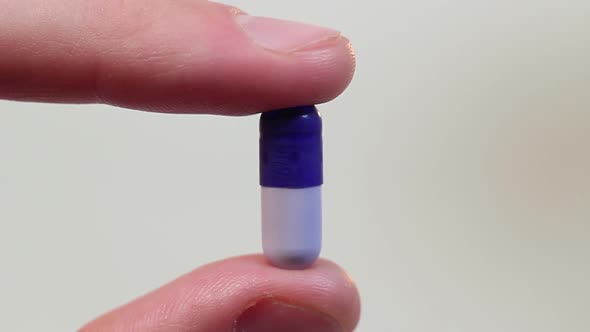 Extreme Close-Up Hand Holding a Capsule, Medicine and Drugs