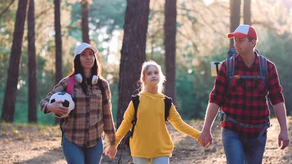 Happy Family Hiking Through a Forest