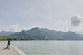 Rear view of woman strolling with pushchair waterfront at Lake Annecy, Annecy, Auvergne-Rhone-Alpes, - PhotoDune Item for Sale