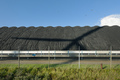 A windturbine throws its shadow over a pile of coal that waits to be burned in the nearby power - PhotoDune Item for Sale