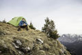 Young male hiker drinking coffee in front of tent on Klammspitze mountain, Oberammergau, Bavaria, - PhotoDune Item for Sale