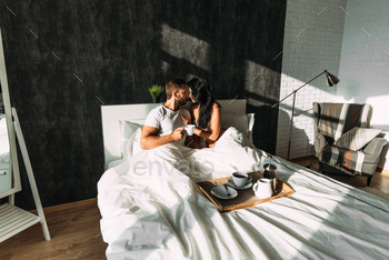 st in bed. Tea in bed. The relationship between a man and a woman. Loving couple. Family at home. Morning lovers. Family relationships. Good morning