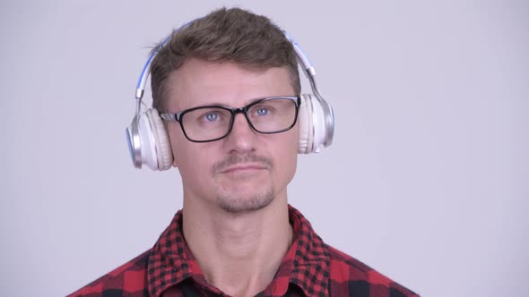 Face of Handsome Bearded Hipster Man Listening To Music