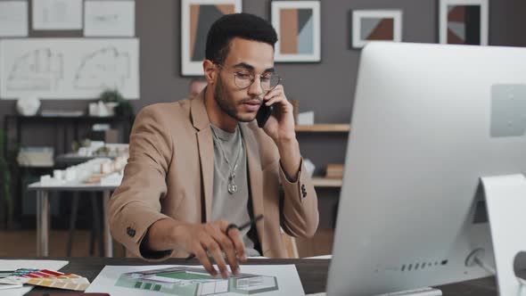 Biracial Designer Talking on Cellphone