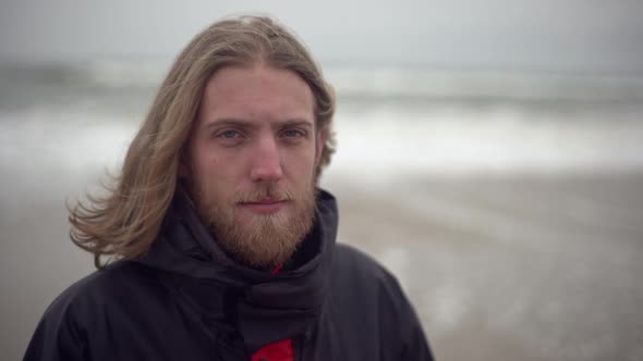 Closeup Portrait of Longhaired Man Having European Appearance Spending Time Near Seaside Looking