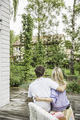 Rear view of couple sitting on garden patio - PhotoDune Item for Sale