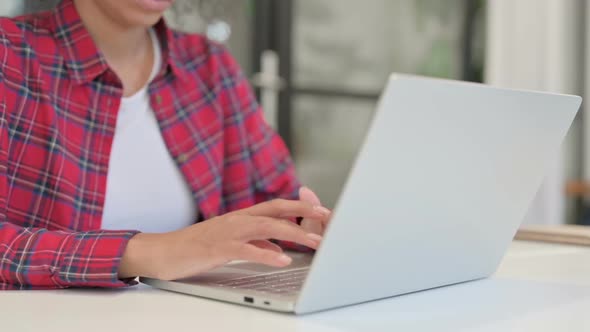 Hands of African Woman Working on Laptop