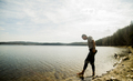 Young male hiker taking apprehensive paddle in lake - PhotoDune Item for Sale