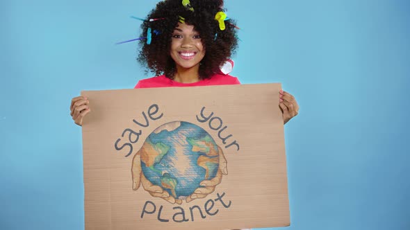 Woman  holding placard with inscription save your planet.