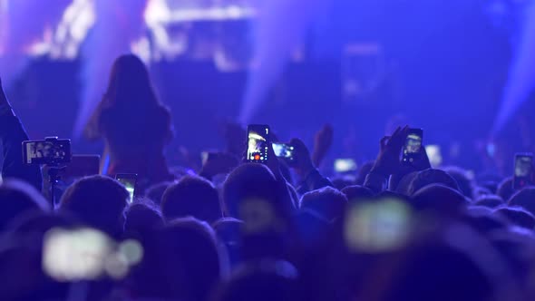 Fires Lighting, Flashes Blinking and Smokes Coming Out During Show on Rock Concert. Spectators