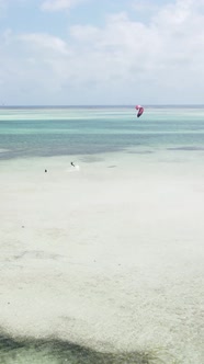 Vertical Video Kitesurfing Near the Shore of Zanzibar Tanzania