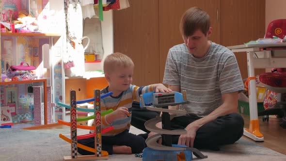 Man And Boy Playing Cars