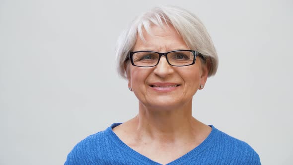 Portrait of Senior Woman in Glasses Over Grey 5