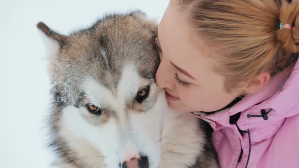 Young Woman Caresses the Dog