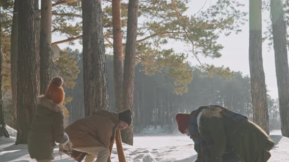 Slowmo of Family of Three Snowball Fighting in Forest