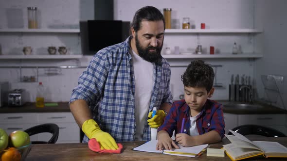Busy Single Dad Cleaning House While Son Studying