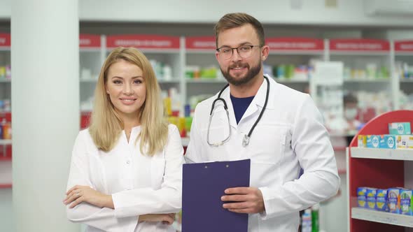 Portrait of Two Beautiful Pharmacist in Uniform at Modern Drugstore