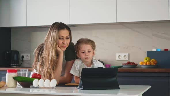 Daughter Consults Mother in Kitchen