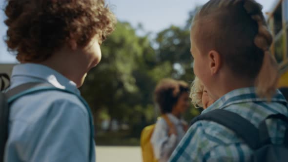 Elementary Age Boys Talking Joking at School Bus