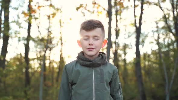 Boy Resting in Autumn Forest