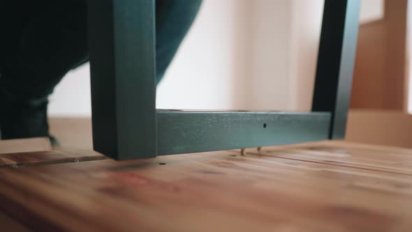 Attaching Metal Legs Into Wooden Top Of DIY Table. - close up