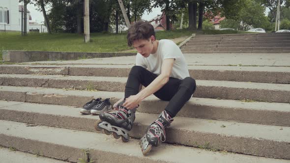 Young Man Puts on Roller Skates