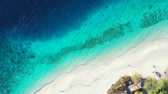 Aerial nature of tranquil coast beach journey by aqua blue ocean and white sand background of a dayo