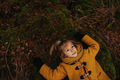 Portrait of Little Blonde Girl Lying on the Ground in the Autumn Forest - PhotoDune Item for Sale