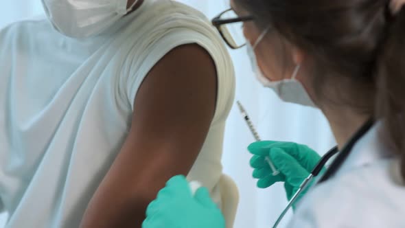 Young Man Visits Skillful Doctor at Hospital for Vaccination