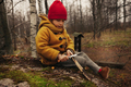 Little Girl Sitting in the Forest and Planing a Stick With a Knife - PhotoDune Item for Sale