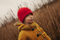 Outdoor Autumn Portrait of a Girl in Yellow Coat and Red Hat Smiling at the Camera - PhotoDune Item for Sale