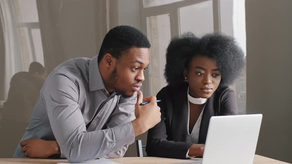 African American Satisfied Woman and Man Working Together in Office