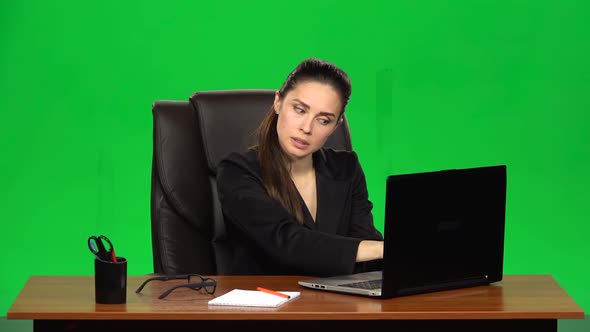 Stressed Woman Enthusiastically Works Behind a Laptop and Very Angry