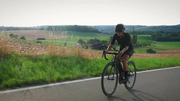 Woman cycling at sunset