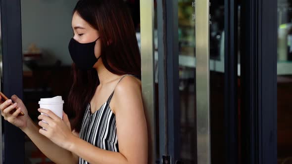 Young Asian Woman Wearing Face Mask While Leaving a Coffee Cafe Shop