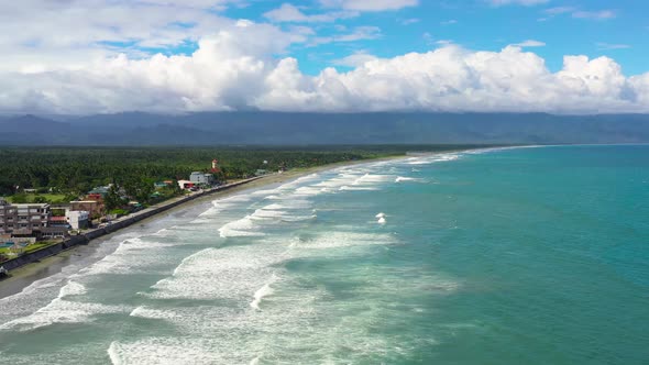 Sandy Beach with Tourists and Surfers. Baler Philippines