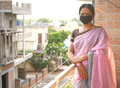Woman standing at balcony wearing medical protective masks. - PhotoDune Item for Sale
