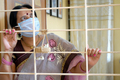 Woman in quarantine looking through the window - PhotoDune Item for Sale