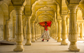Young female tourist dancing at Pillars room of Amber Fort, Jaipur - PhotoDune Item for Sale