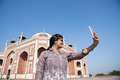 Young girl taking Photos in front of Humayun's Tomb, Delhi, India. - PhotoDune Item for Sale
