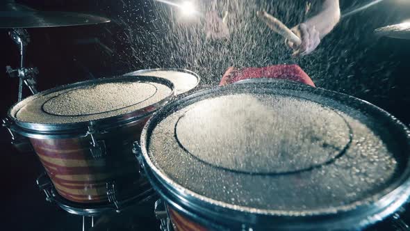 Water on Drums While Man Plays It.