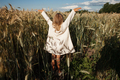 Child in White Dress Cheering in the Rye - PhotoDune Item for Sale
