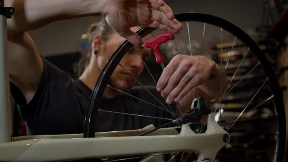 Master Installs Wheel On Bicycle