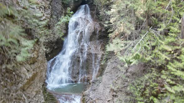 Margaret Falls cascading down a lush, mountain forest in the stunning Herald Provincial Park in Brit