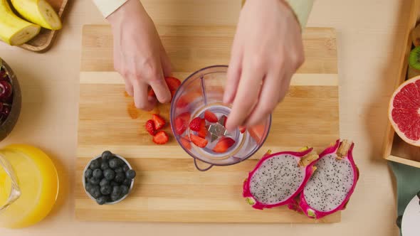Woman Hands Putting Ripe Strawberries and Blueberries Into Blender Closeup Cooking Smoothie Healthy