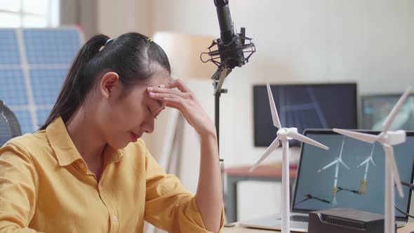 Close Up Of Asian Woman Being Upset Failing Testing The Wind Turbine While Working With Laptop